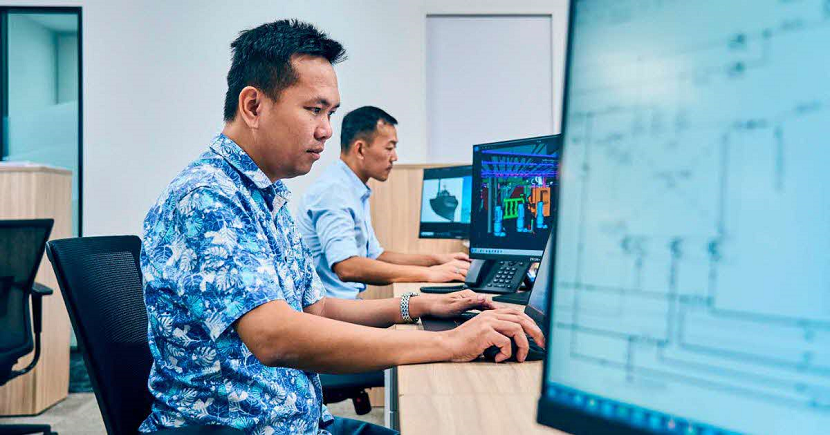 Senior engineer Thomas Truong Ngoc (front) reviews plans for the firm’s first CSOV at Marco Polo Marine’s Singapore headquarters. The vessel features a stable platform for maintenance crews to access wind turbines safely in rough weather conditions. PHOTO: SPH MEDIA